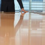 Person standing at large conference table.