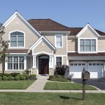 Two-story suburban house with manicured lawn.