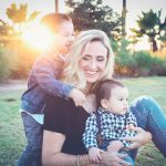 Mother with two children in a park.