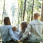 Family sitting together in a forest.
