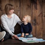 Mother and child sitting with a map.