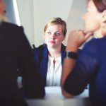 Three people having a business meeting discussion.