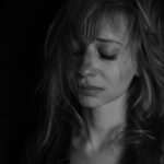 Woman with closed eyes in black and white.