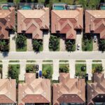 Aerial view of suburban houses and street.